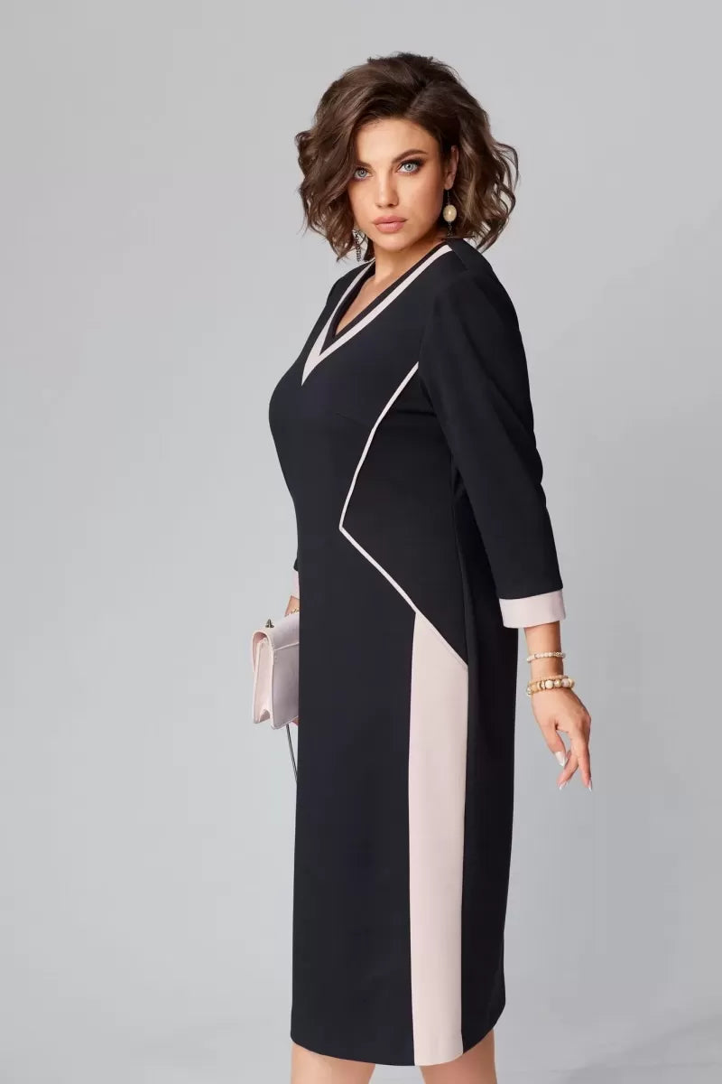 Woman wearing a black and white dress with a gray background
