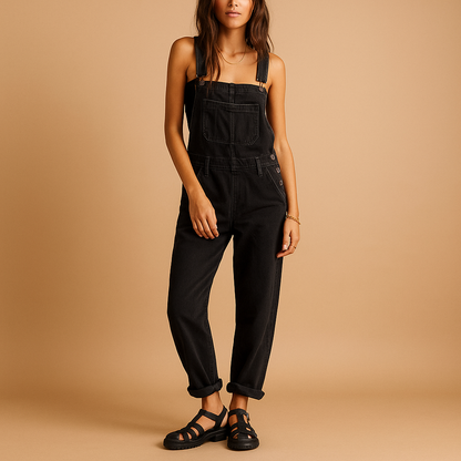 Woman wearing a relaxed denim overall with adjustable straps, styled for casual everyday wear.
