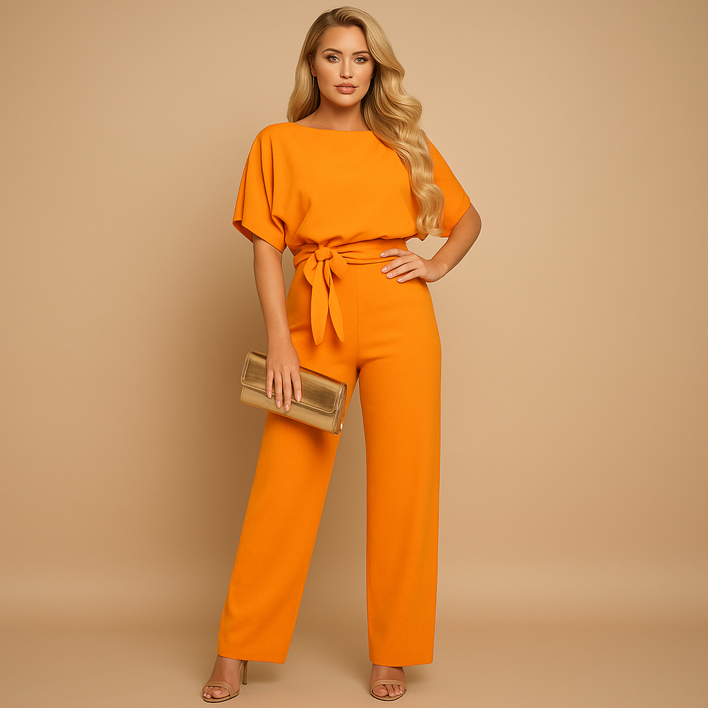 Woman wearing a glitter halter jumpsuit with an open back and flared legs, perfect for galas, parties, and festive occasions.