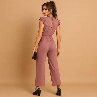 Woman wearing a high-neck tailored jumpsuit with cap sleeves and a waist belt, perfect for formal events, parties, and elegant dinners.