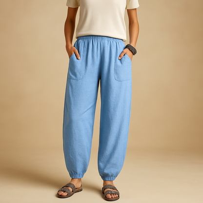 High-waisted boho summer trousers for women with a loose flowing fit and functional pockets, ideal for beach days, travel, and relaxed summer outfits.
