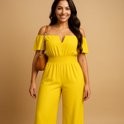 Woman wearing an off-shoulder pleated jumpsuit with an elastic waist, perfect for summer events, beach days, and casual chic outfits.