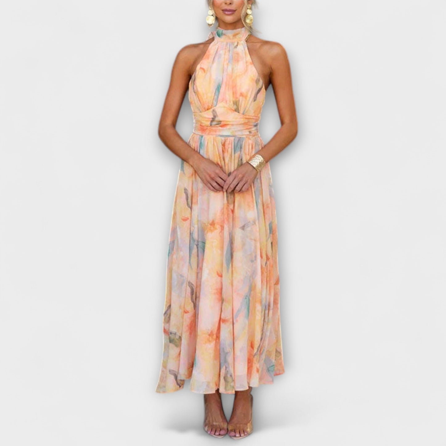 Woman wearing a floral halter neck jumpsuit on a white background