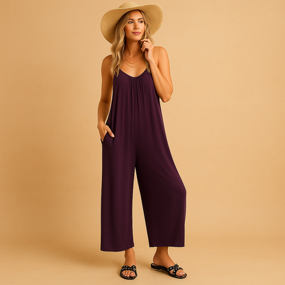 Woman wearing a loose summer jumpsuit with adjustable straps and an elastic waistband, ideal for holidays, parties, and warm days.