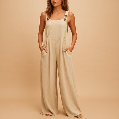 Woman wearing a high-waist wide-leg summer jumpsuit with button details and side pockets, perfect for warm casual days.