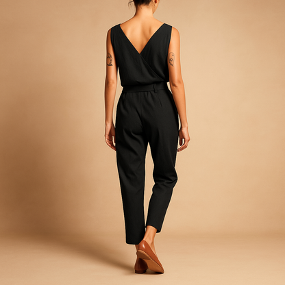Woman wearing a loose-fit V-neck summer jumpsuit with an adjustable waistband, ideal for beach days and casual summer outings.