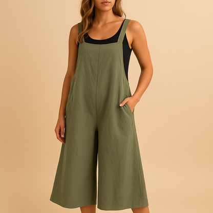 Woman wearing a loose wide-leg cotton-linen jumpsuit in a summer setting, perfect for warm days, casual outings, and relaxed moments.