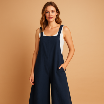 Woman wearing a loose wide-leg cotton-linen jumpsuit in a summer setting, perfect for warm days, casual outings, and relaxed moments.